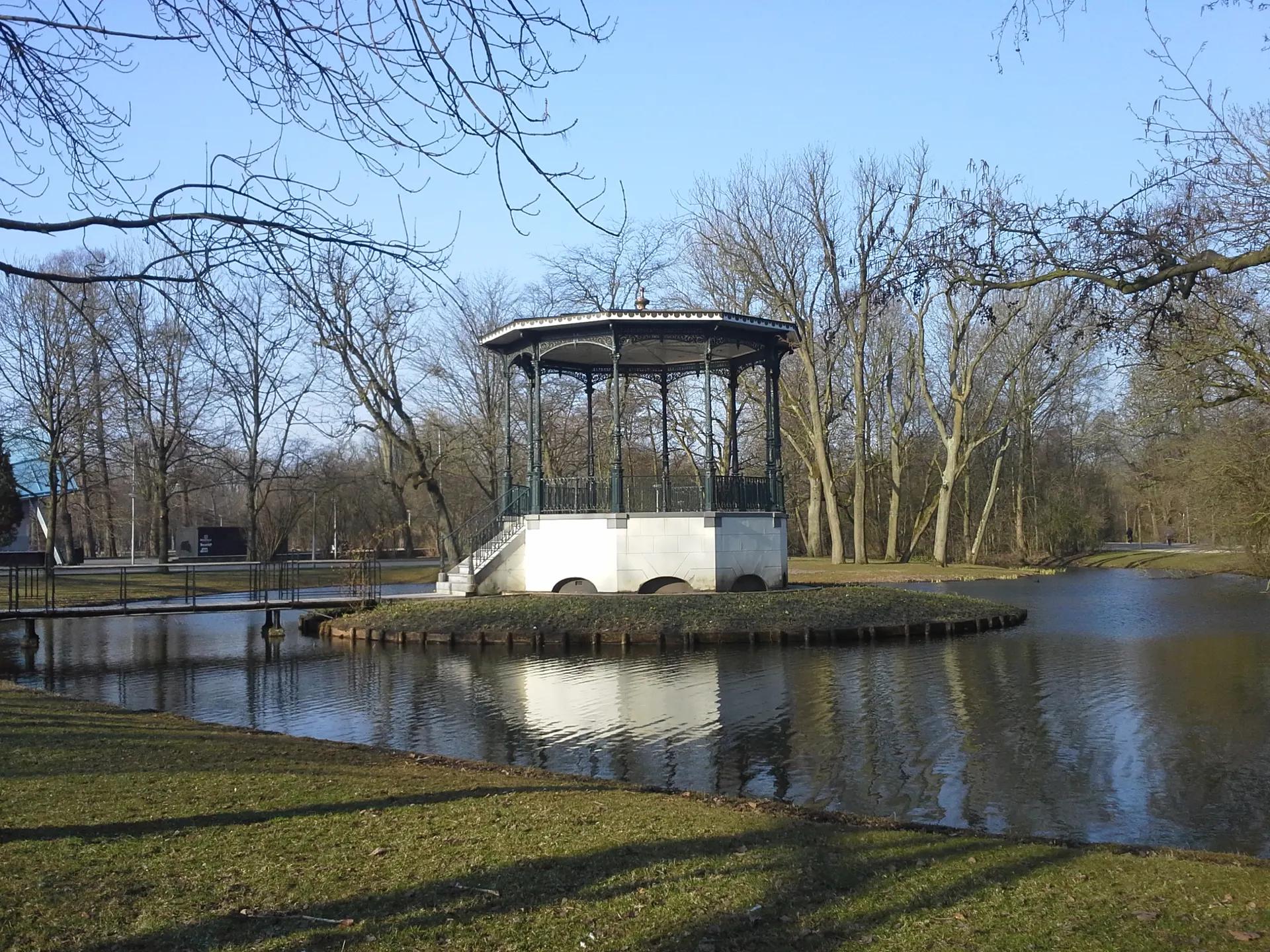 White bandstand pavilion on a small island in a Vondelpark pond