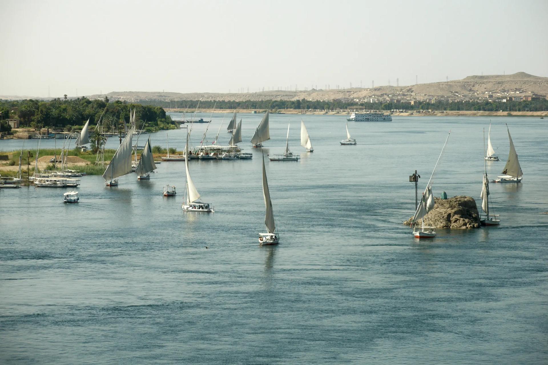 Feluccas sailing on the wide Nile at Aswan between rocky islands