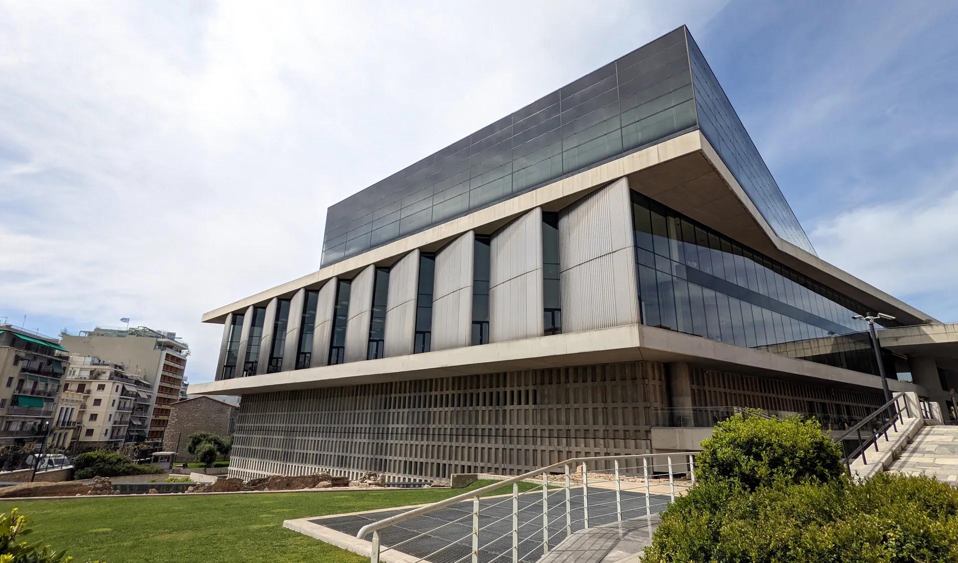 The modern glass and concrete building of the Acropolis Museum