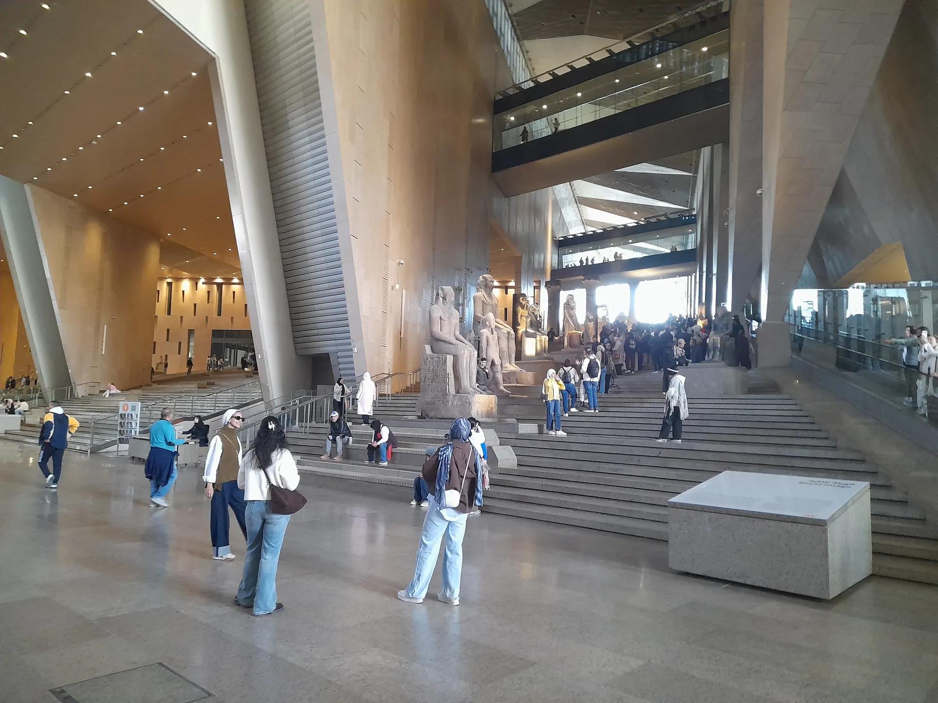Grand Staircase lined with pharaonic statues inside the Grand Egyptian Museum