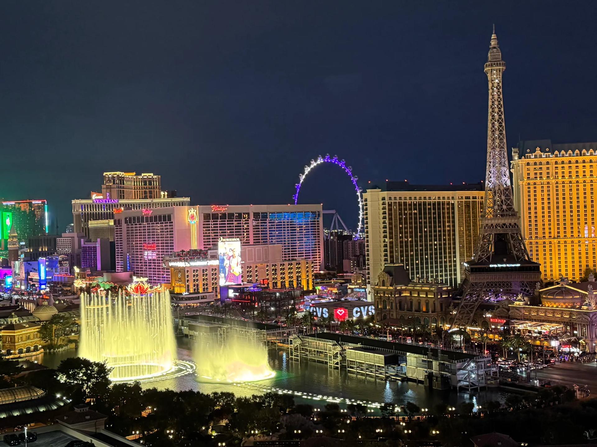 Las Vegas Strip at night with the Bellagio fountains, Paris tower and High Roller wheel