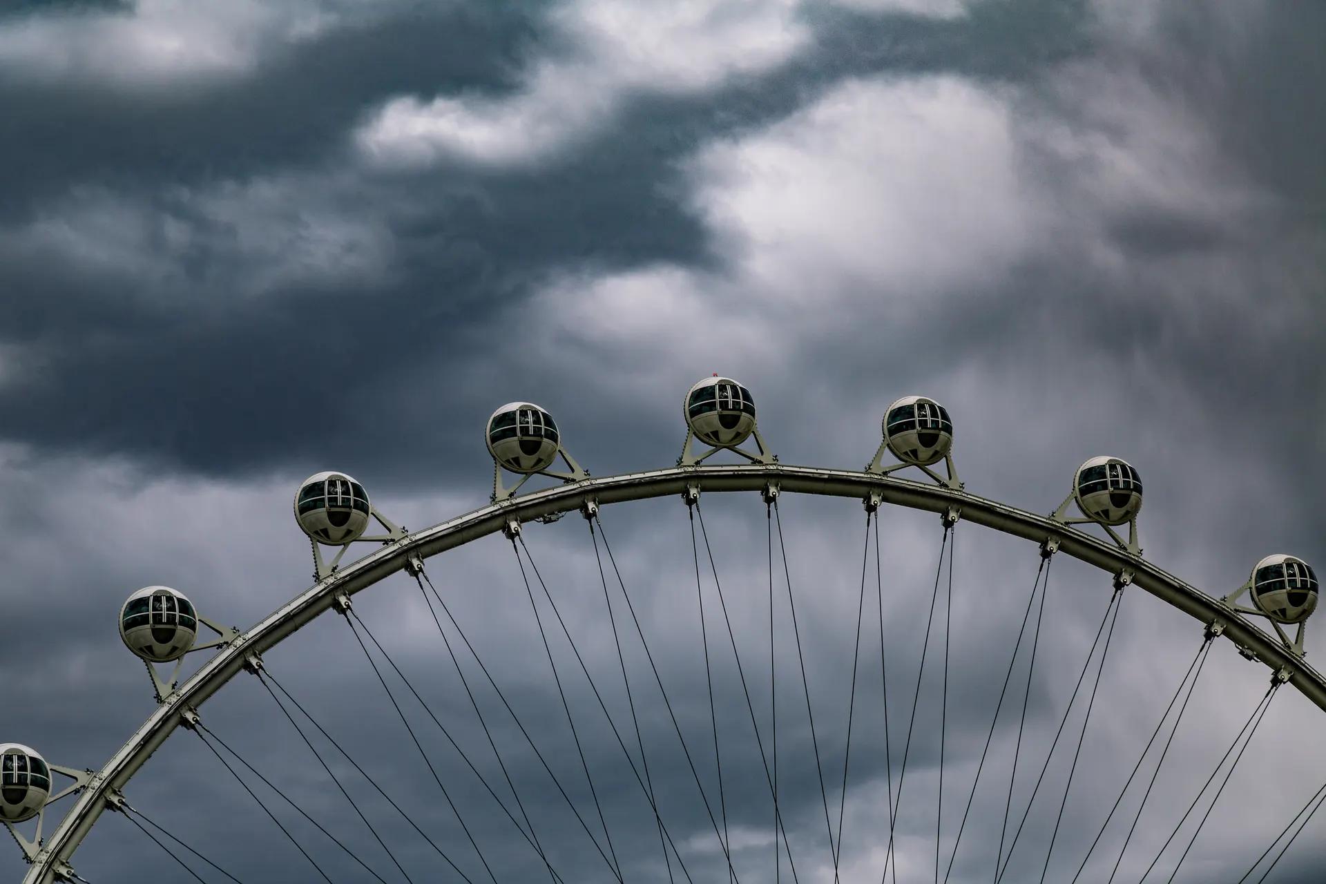 Cabins on the rim of the High Roller observation wheel against a cloudy sky
