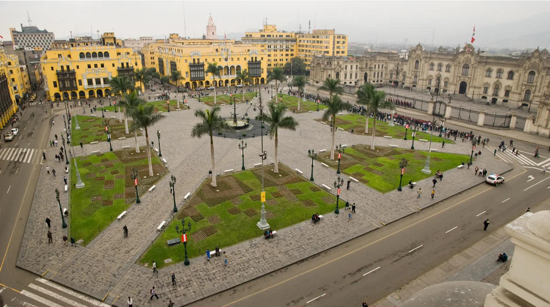 Plaza Mayor of Lima seen from above with palms and yellow colonial buildings