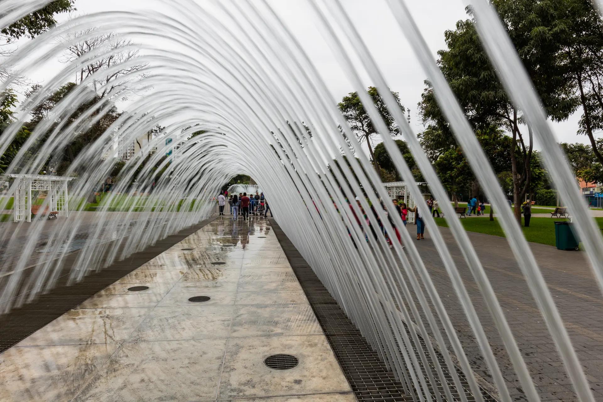 Tunnel of arching water jets at the Magic Water Circuit in Parque de la Reserva