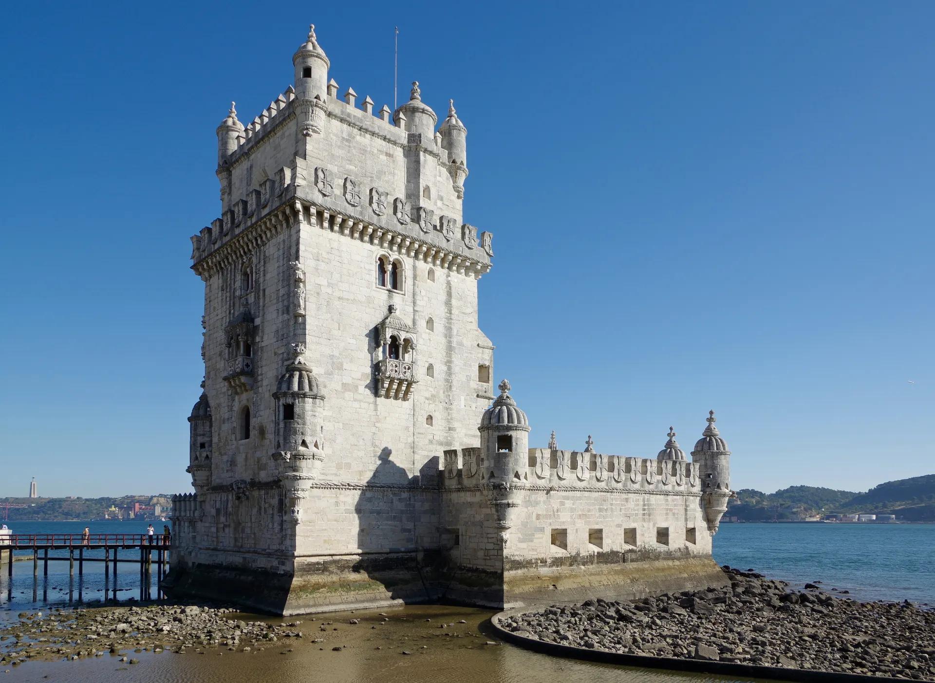 Belém Tower standing at the edge of the Tagus at low tide