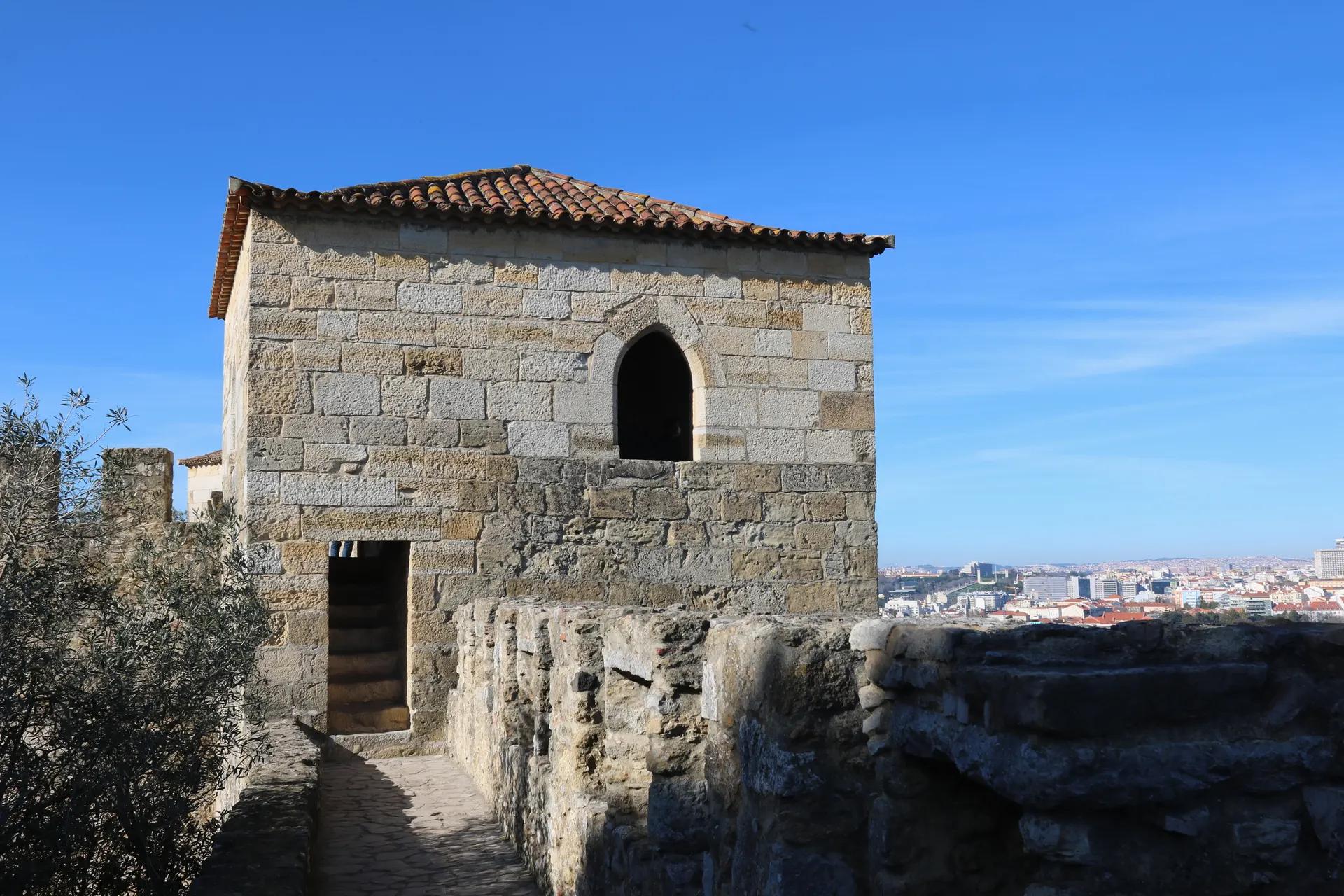 Stone tower and ramparts of São Jorge Castle above the city