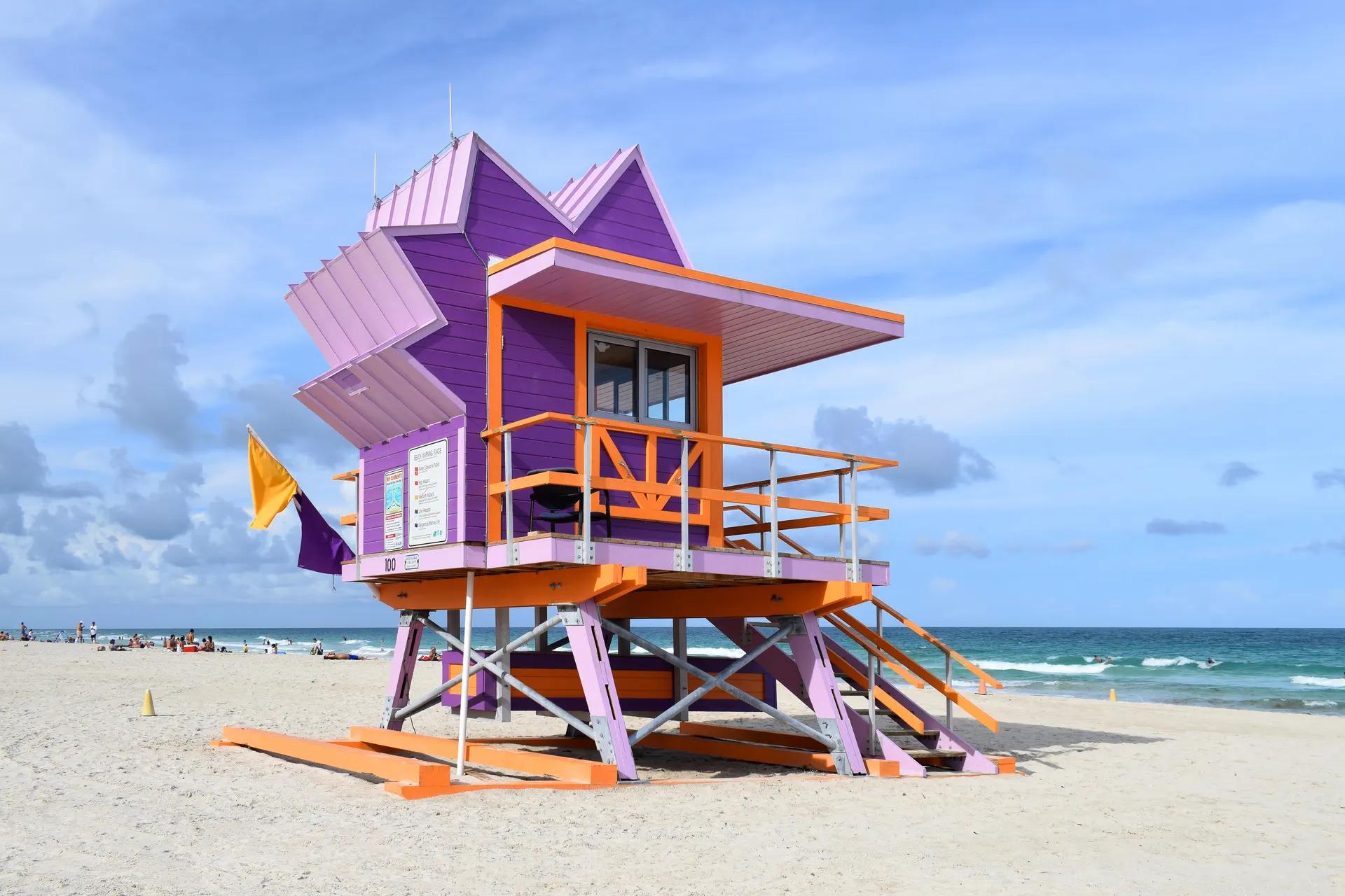 Purple and orange lifeguard tower on the sand at Miami Beach