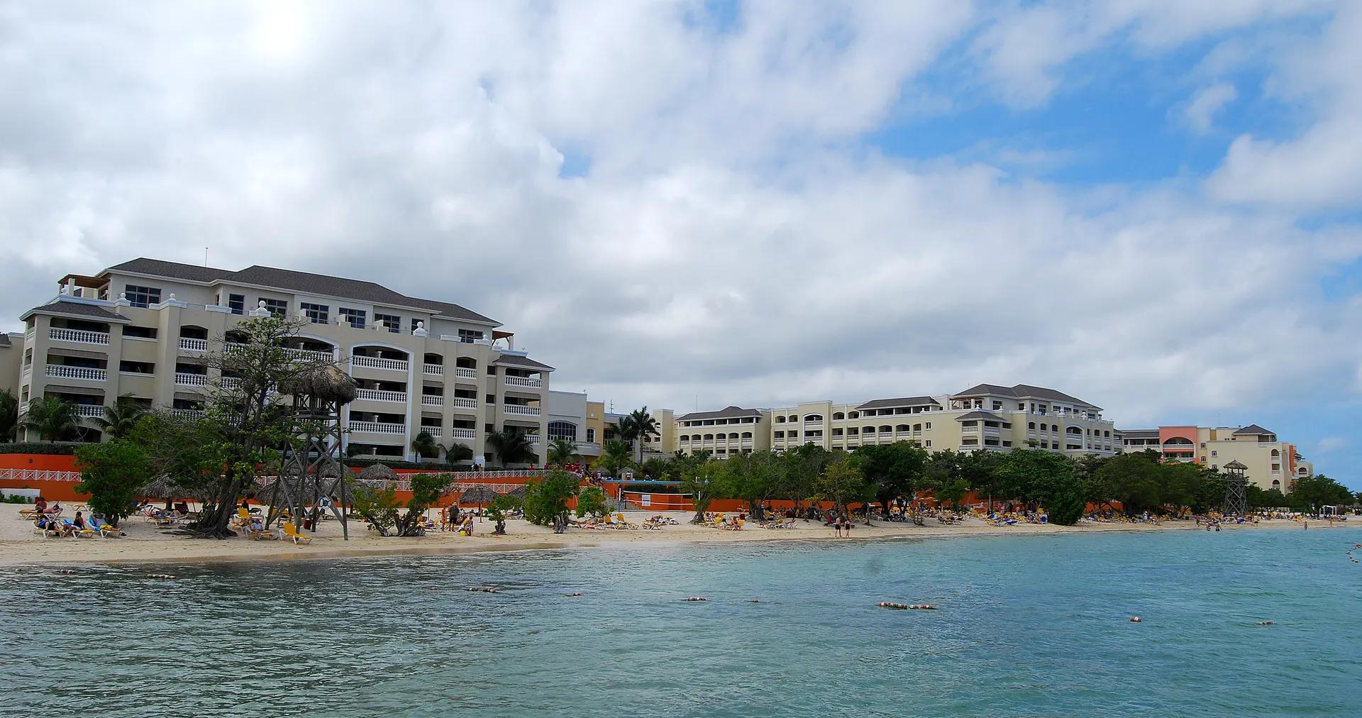 Hotel buildings along the sand and calm water at Rose Hall beach, Montego Bay