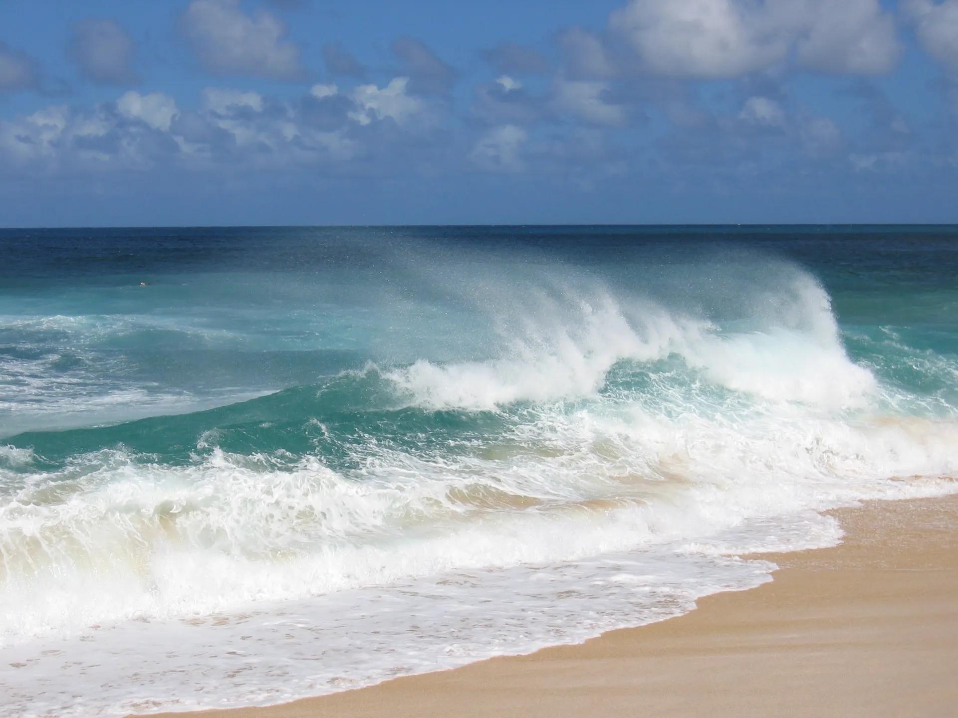 Waves breaking on the sand at Sunset Beach