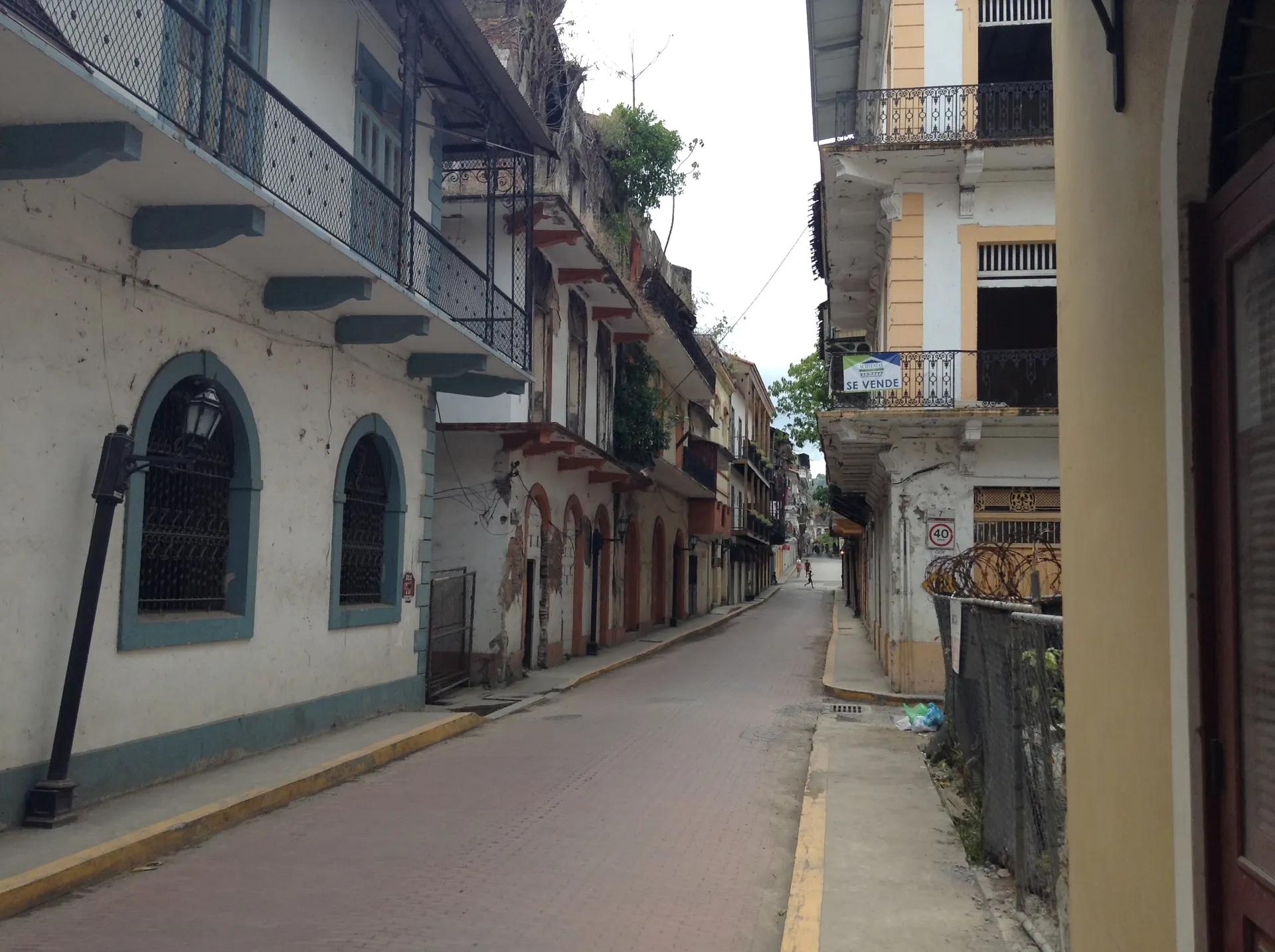 Narrow street with balconied colonial houses in Casco Viejo
