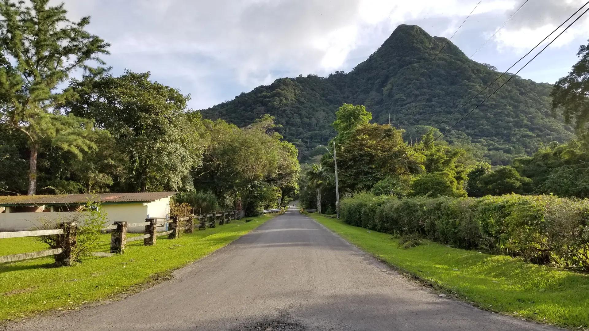 Country road leading to green volcanic hills in El Valle de Antón