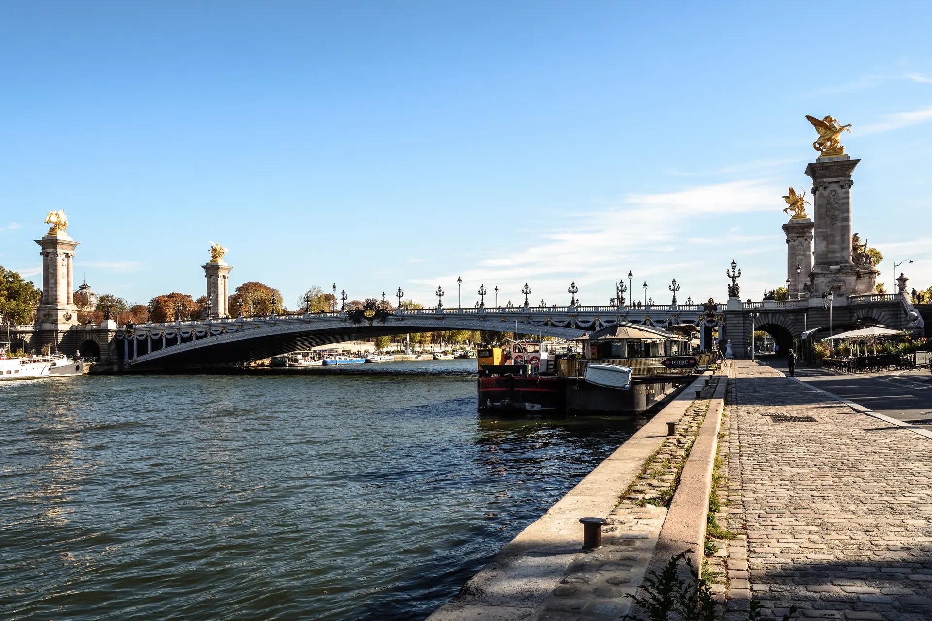 Pont Alexandre III over the Seine seen from the cobbled riverside quay