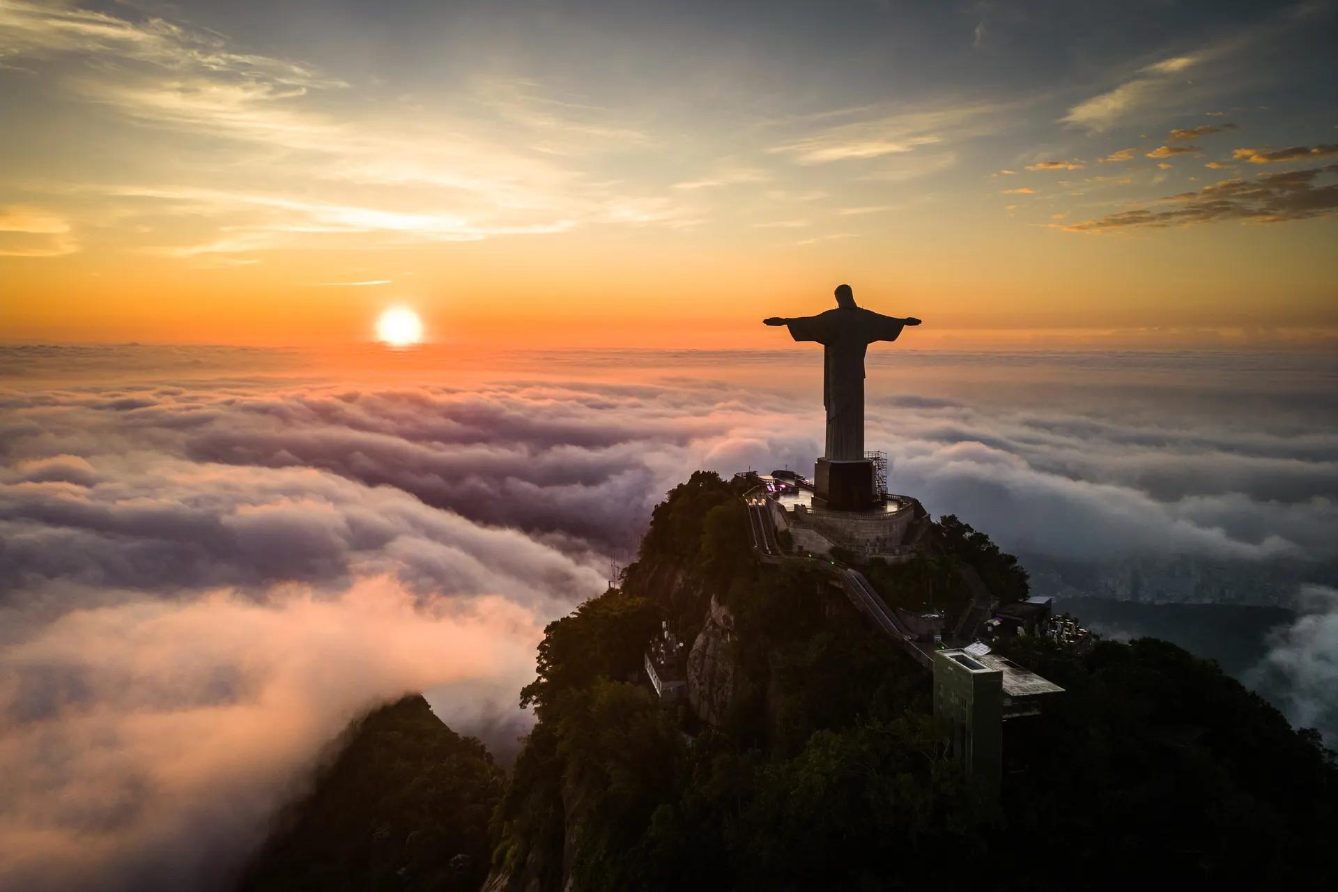 Christ the Redeemer on Corcovado above a sea of clouds at sunrise