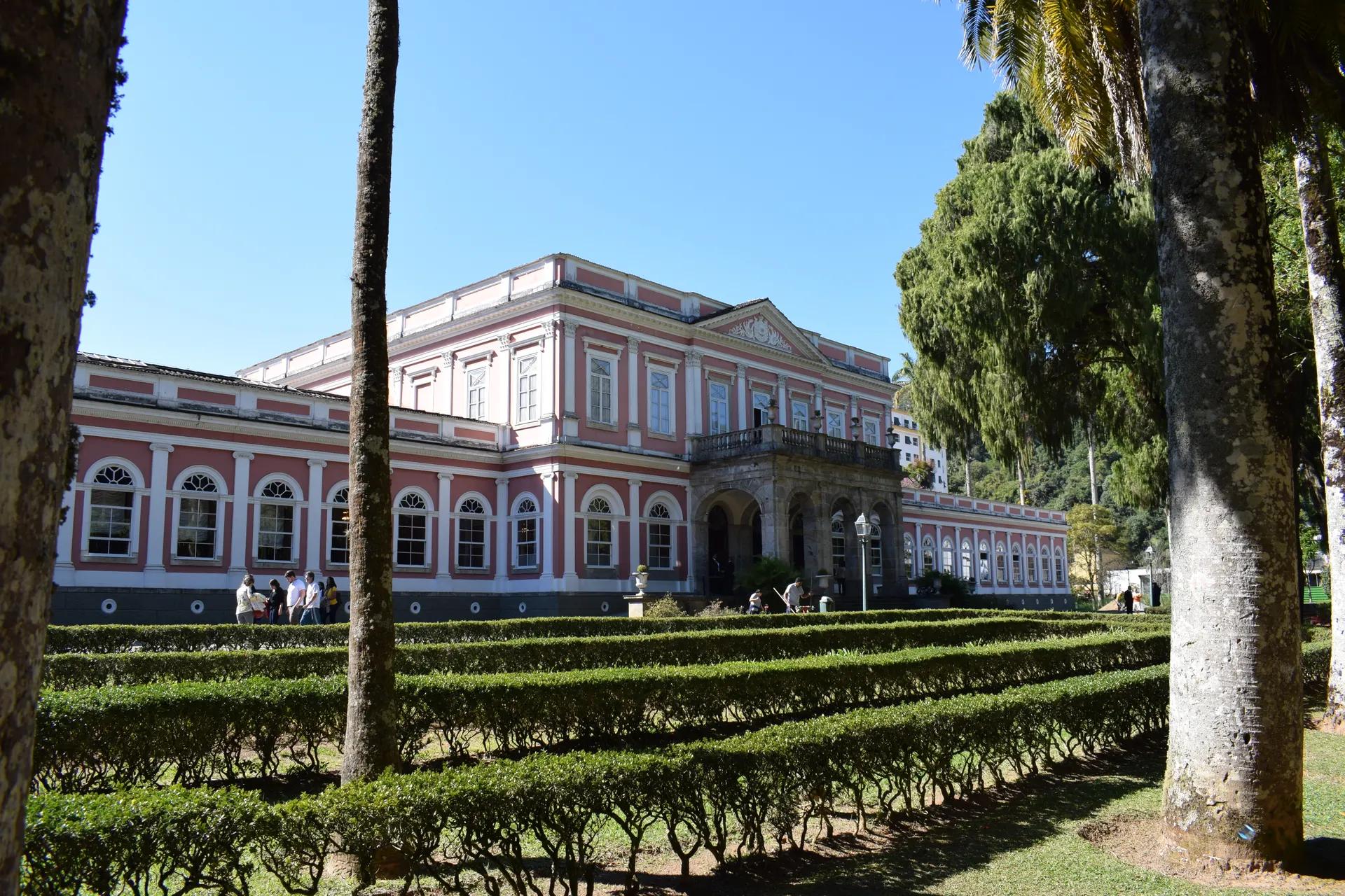 Pink facade of the Museu Imperial in Petrópolis behind clipped hedges