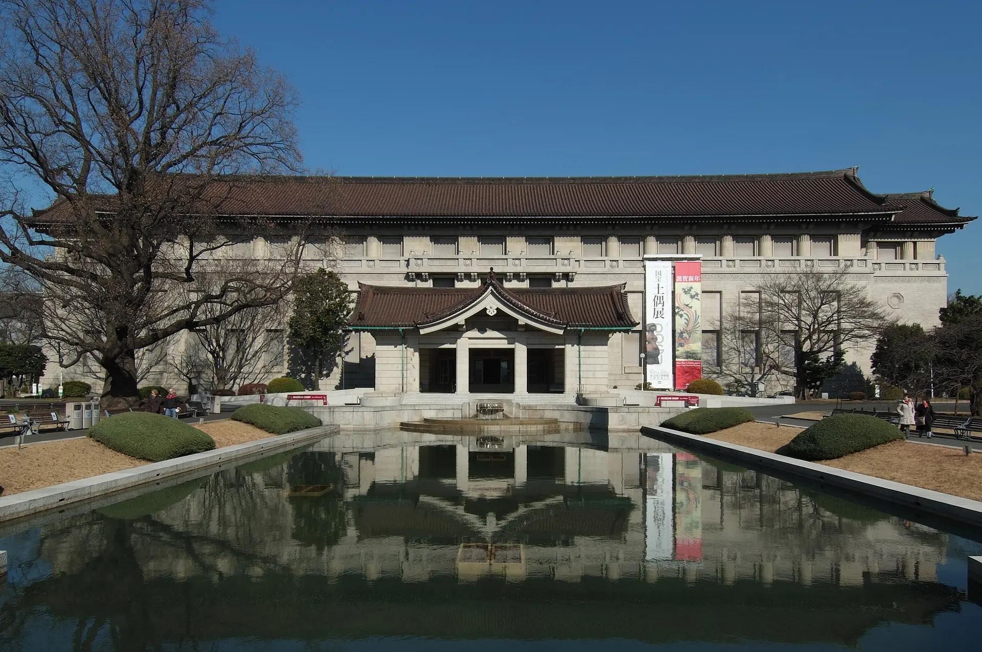 Honkan main building of the Tokyo National Museum reflected in a pond