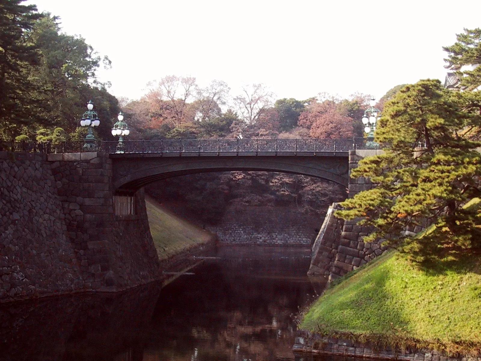 Stone walls and Nijubashi bridge over the moat of the Imperial Palace in Tokyo