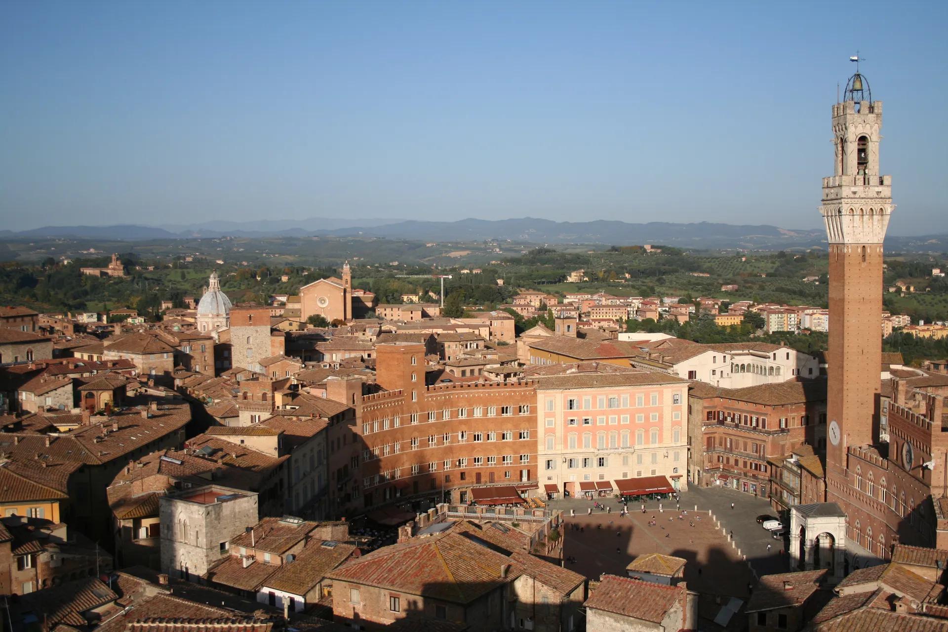 Piazza del Campo in Siena with the Torre del Mangia and hills beyond