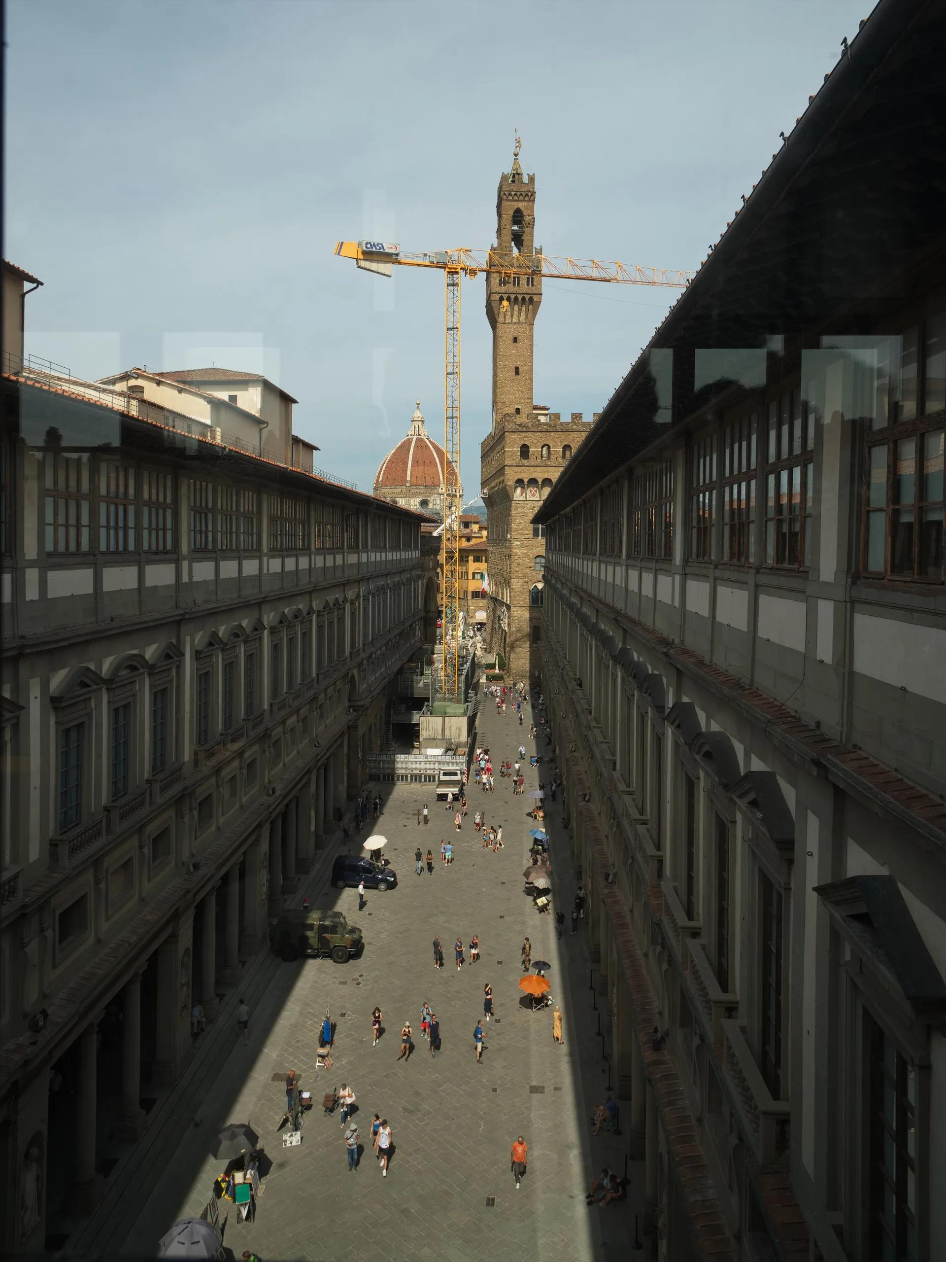 The Uffizi courtyard seen from the south wing, with Palazzo Vecchio and the cathedral dome at the end