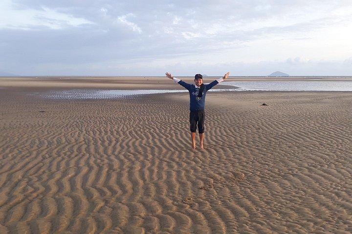 川と海が出会うロンリービーチでの日の出の写真