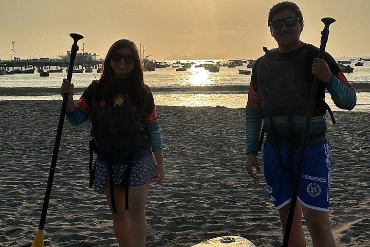 Paddle surfing experience at sunset