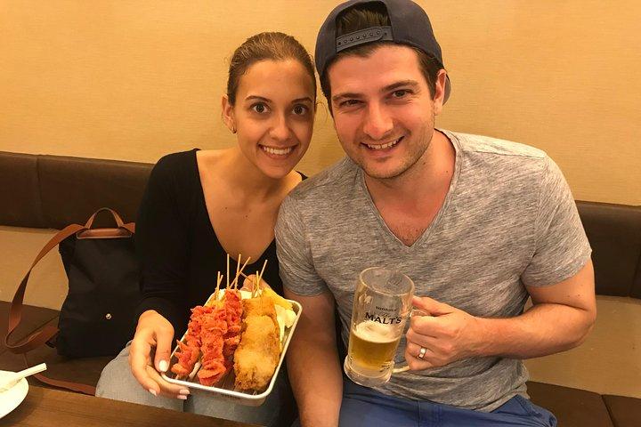 Tour gastronomico locale privato di Osaka a Dotonbori